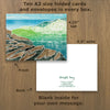 Note cards showcasing a jigsaw print by New England artist, Hannah Phelps, of surf on the Maine coast.