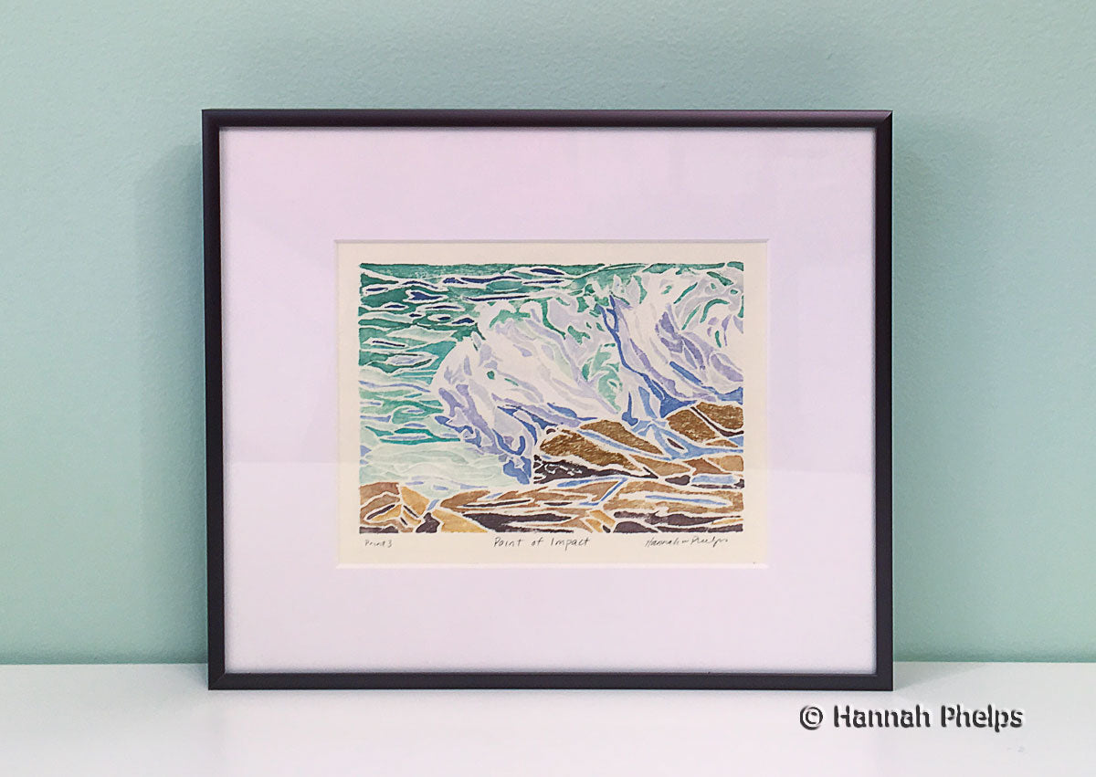 Framed white-line woodcut print of a wave crashing on rocks in Maine by New England artist, Hannah Phelps